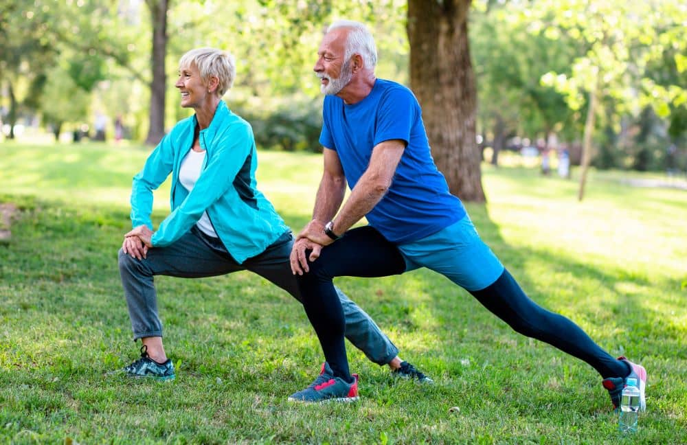 Senior couple doing stretching exercise.